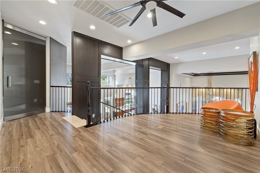 9624 Grand Isle Lane, Las Vegas, NV 89144 An open upper landing showcases handsome wood flooring and overlooking metal railings.