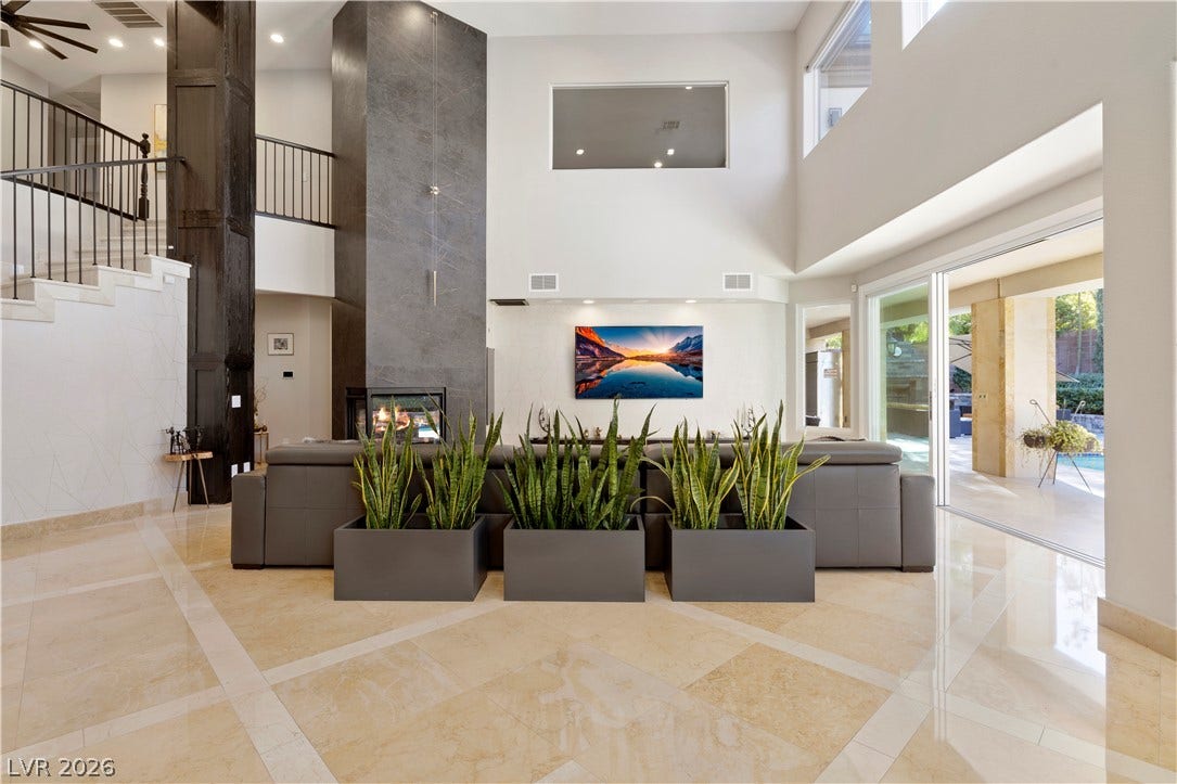 9624 Grand Isle Lane, Las Vegas, NV 89144 Gleaming tile floors and soaring ceilings define this modern living space with sliding glass doors.