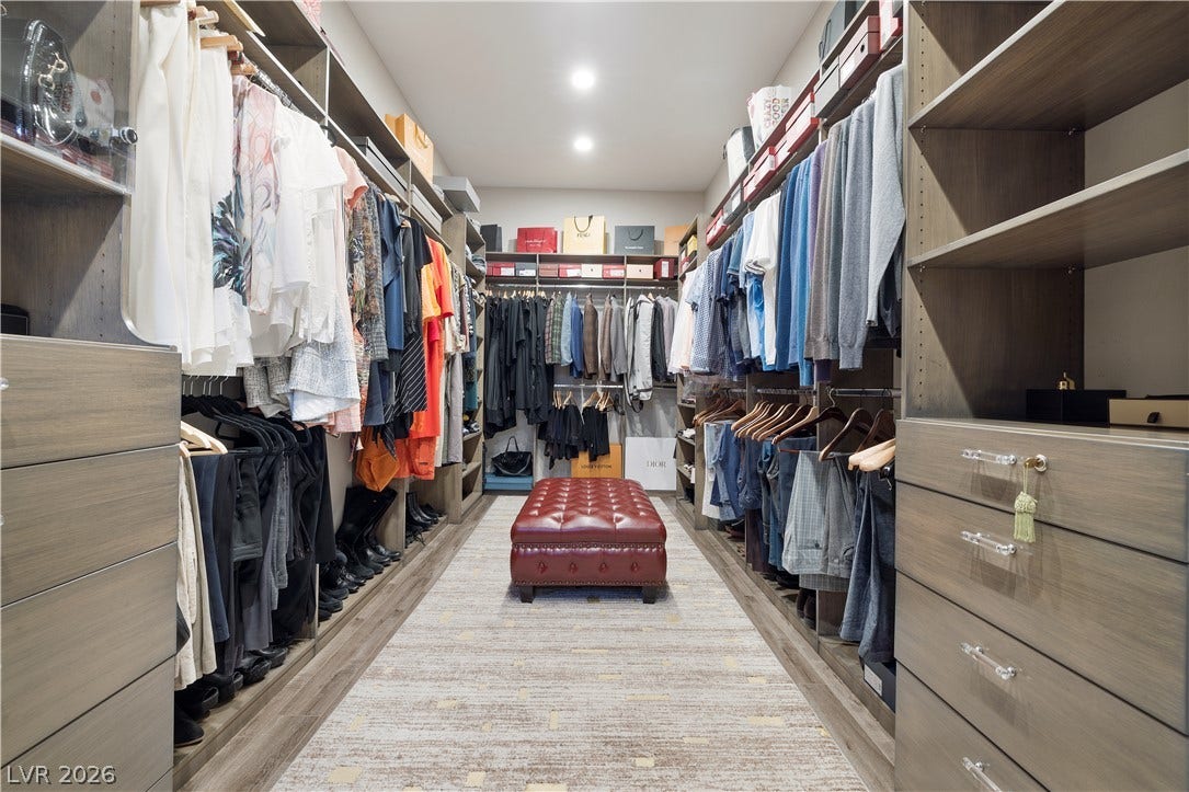 9624 Grand Isle Lane, Las Vegas, NV 89144 Custom built-in shelving and smooth wood flooring define this spacious walk-in closet.