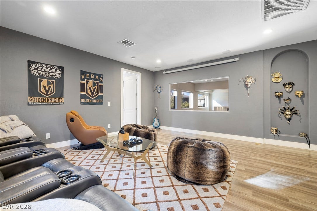 9624 Grand Isle Lane, Las Vegas, NV 89144 Gleaming wood-look floors and clean architectural lines define this versatile recreation space.