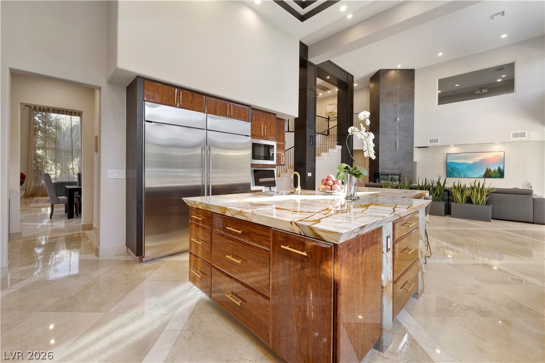9624 Grand Isle Lane, Las Vegas, NV 89144 Polished stone flooring and soaring ceilings frame this open culinary space and adjacent living area.
