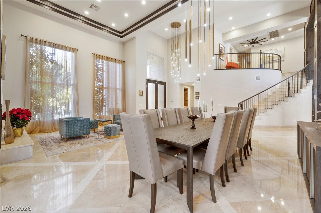 9624 Grand Isle Lane, Las Vegas, NV 89144 Polished tile flooring and double-height ceilings define this grand, open-concept dining space.