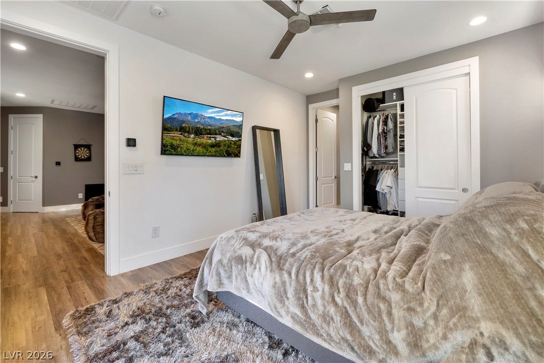 9624 Grand Isle Lane, Las Vegas, NV 89144 Smooth wood flooring and recessed lighting define this comfortable modern bedroom retreat.