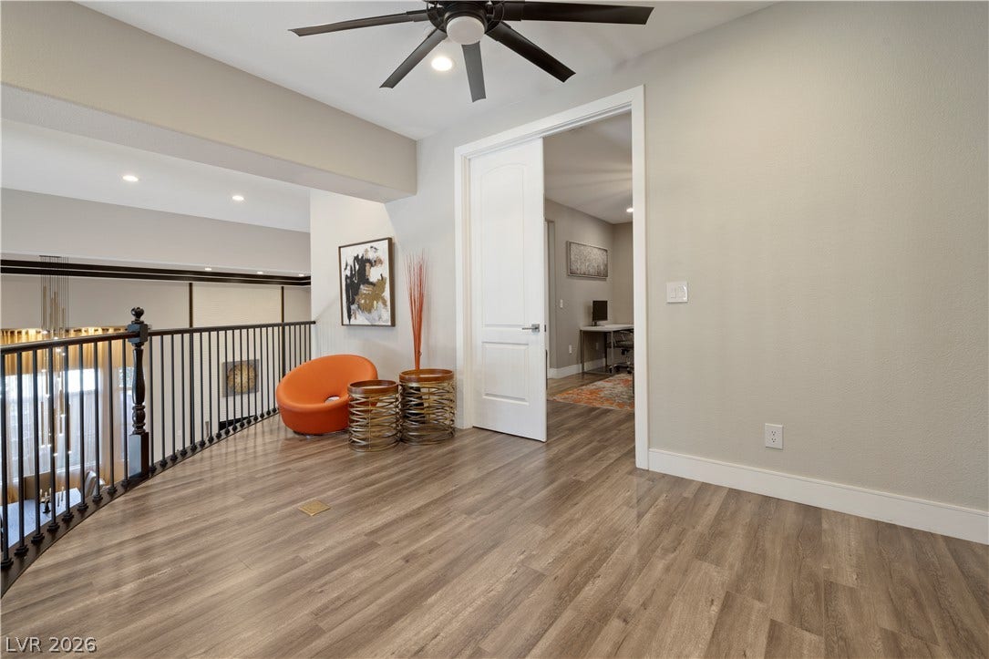 9624 Grand Isle Lane, Las Vegas, NV 89144 Polished wood floors and a custom iron railing highlight this versatile upper level loft space.