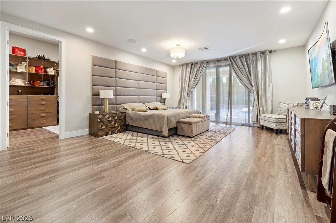 9624 Grand Isle Lane, Las Vegas, NV 89144 Polished hardwood flooring runs through this spacious suite featuring recessed lighting and sliding glass doors.
