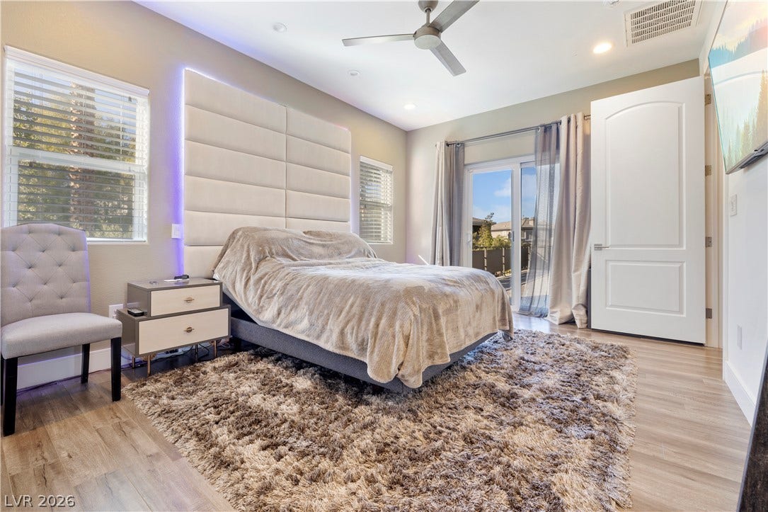 9624 Grand Isle Lane, Las Vegas, NV 89144 Recessed lighting and wide wood-plank flooring define this comfortable bedroom space.