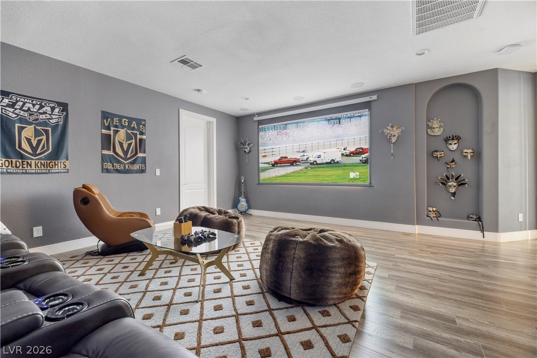 9624 Grand Isle Lane, Las Vegas, NV 89144 Clean lines and smooth flooring define this versatile recreation room featuring an arched wall niche.