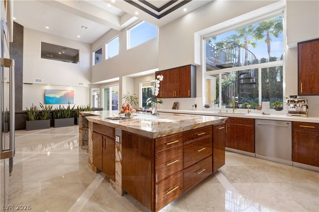 9624 Grand Isle Lane, Las Vegas, NV 89144 Soaring ceilings and polished stone flooring elevate this architectural kitchen design.
