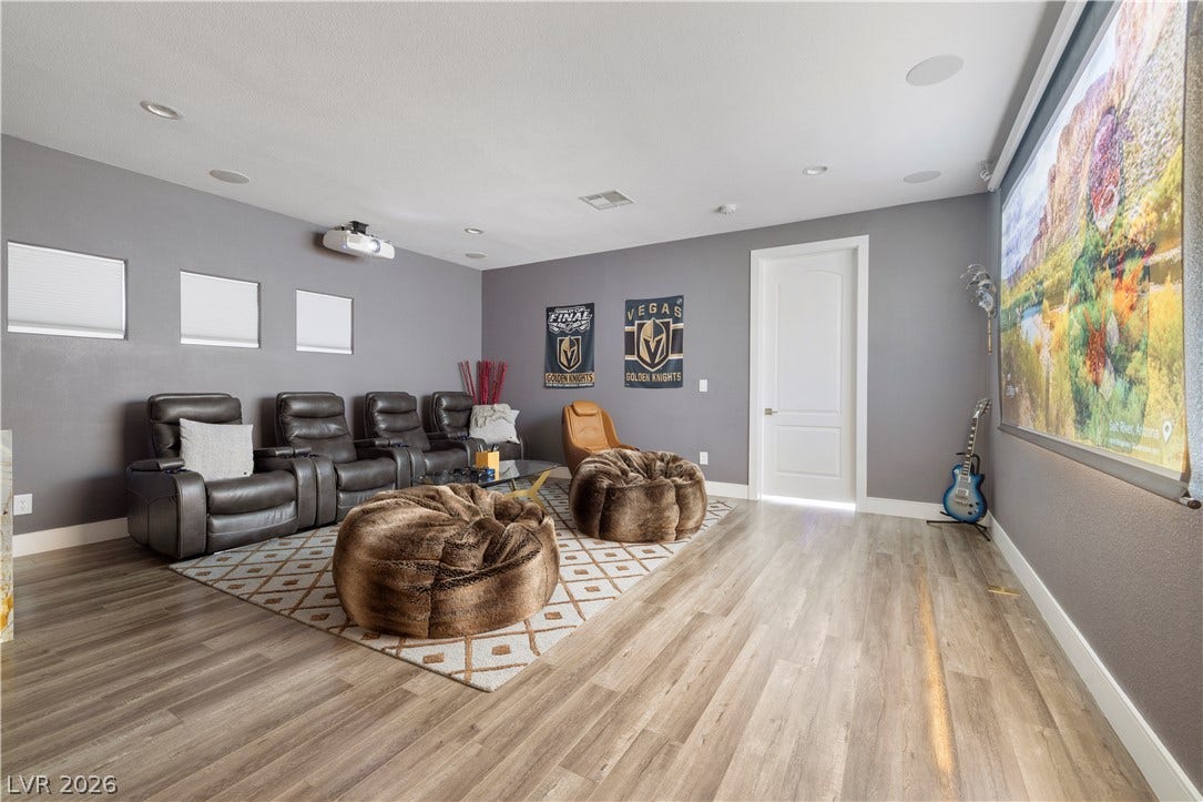 9624 Grand Isle Lane, Las Vegas, NV 89144 Smooth wood-style flooring runs through this comfortable home media room featuring built-in ceiling speakers.