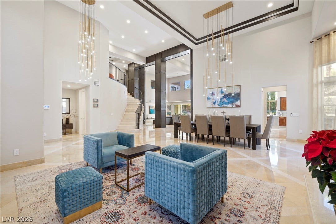 9624 Grand Isle Lane, Las Vegas, NV 89144 Polished stone flooring and soaring tray ceilings define this grand dual-purpose living and dining space.