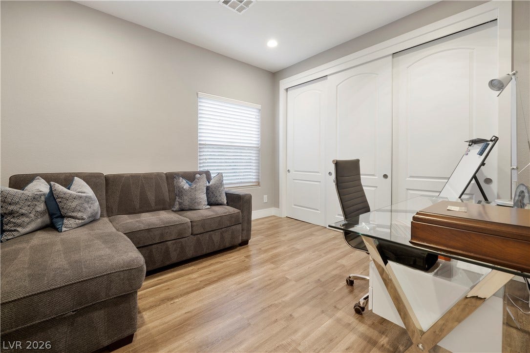 9624 Grand Isle Lane, Las Vegas, NV 89144 Smooth wood flooring and sliding closet doors define this versatile home workspace.