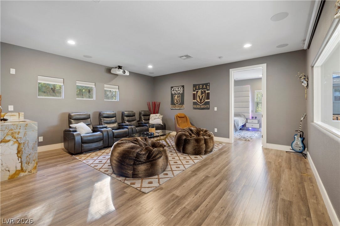 9624 Grand Isle Lane, Las Vegas, NV 89144 Gleaming wood-look floors and smooth recessed lighting define this versatile home entertainment space.