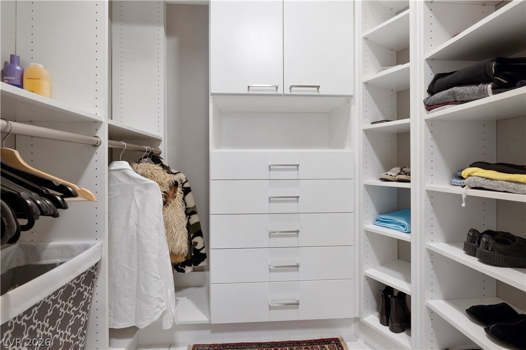 9624 Grand Isle Lane, Las Vegas, NV 89144 Floor-to-ceiling custom shelving and integrated dressers maximize efficiency in this organized walk-in closet.