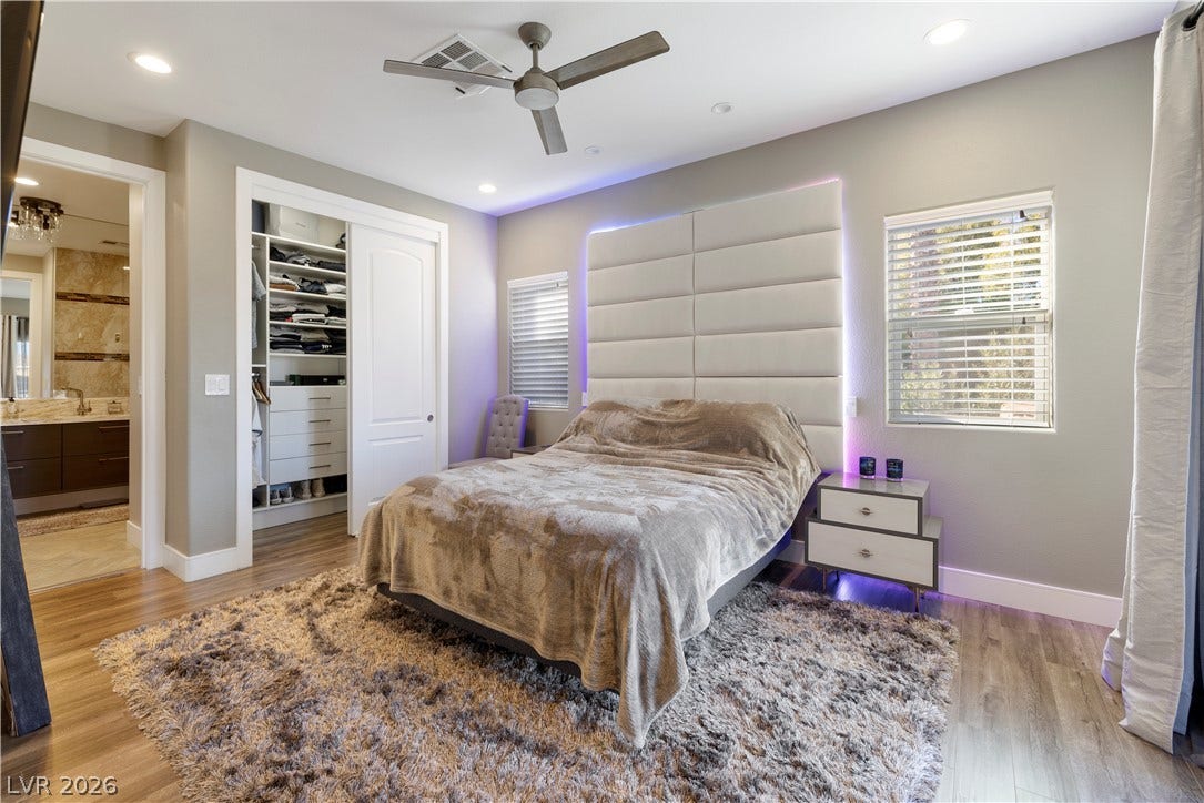 9624 Grand Isle Lane, Las Vegas, NV 89144 Smooth wood-look flooring and recessed lighting define this comfortable modern bedroom suite.