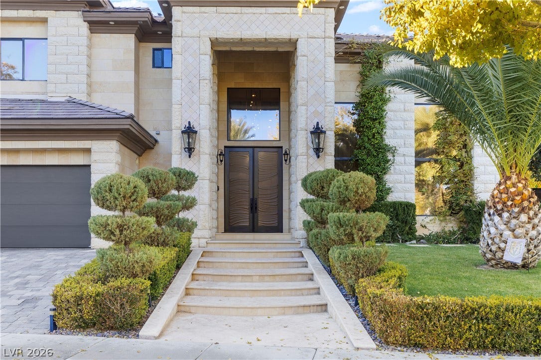 9624 Grand Isle Lane, Las Vegas, NV 89144 Grand stone archways and stately double doors create an impressive entry to this residence.