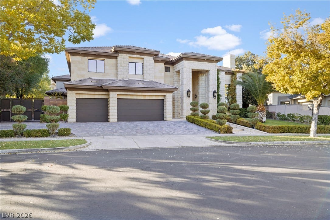 9624 Grand Isle Lane, Las Vegas, NV 89144 An elegant stone facade and manicured hedges define this impressive two-story residence.