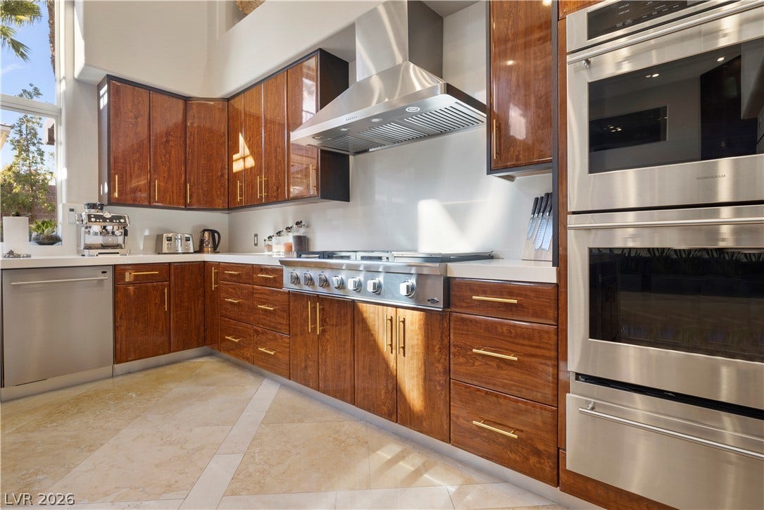 9624 Grand Isle Lane, Las Vegas, NV 89144 Rich wood cabinetry and professional stainless steel appliances ground this gourmet kitchen design.