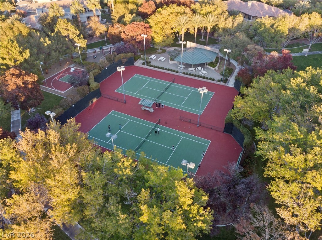 9624 Grand Isle Lane, Las Vegas, NV 89144 Lush mature trees surround double outdoor tennis courts and a basketball court.