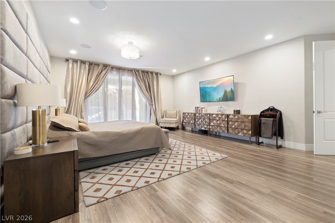 9624 Grand Isle Lane, Las Vegas, NV 89144 Recessed lighting and warm wood flooring enhance this generously proportioned bedroom space.