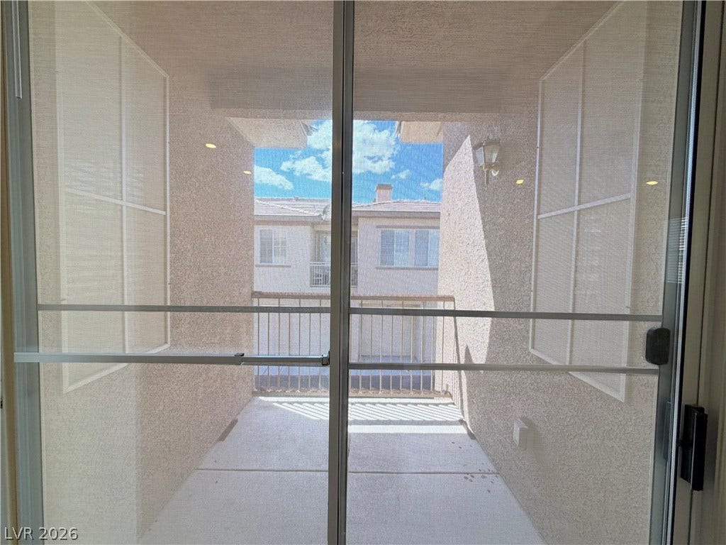 10221 Deerfield Beach Avenue, #202, Las Vegas, NV 89129 Sliding doors open to a private covered balcony perfect for enjoying clear blue skies.