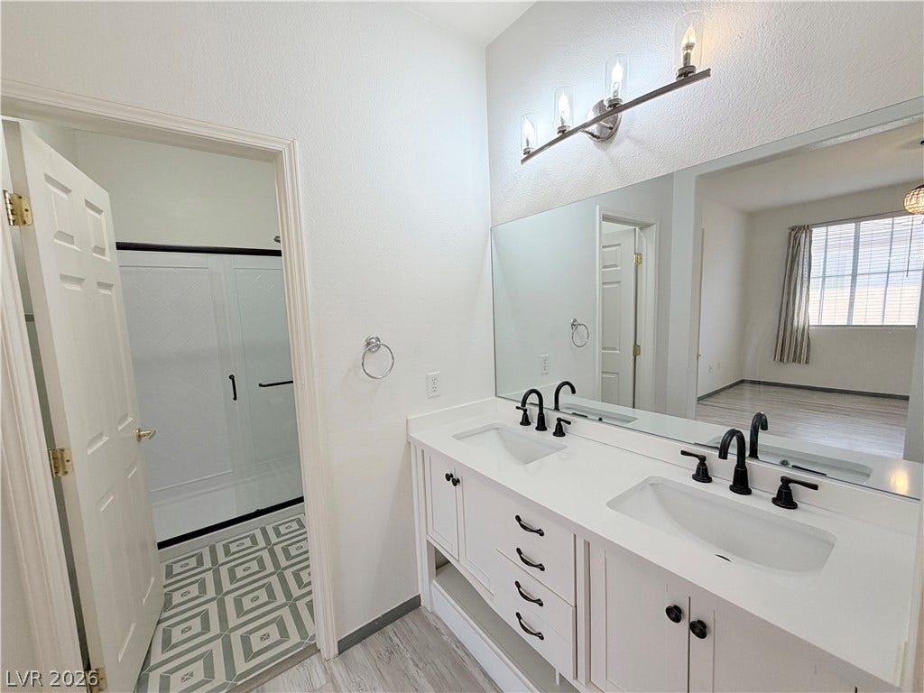10221 Deerfield Beach Avenue, #202, Las Vegas, NV 89129 Clean lines and a spacious double vanity anchor this modern bathroom design.