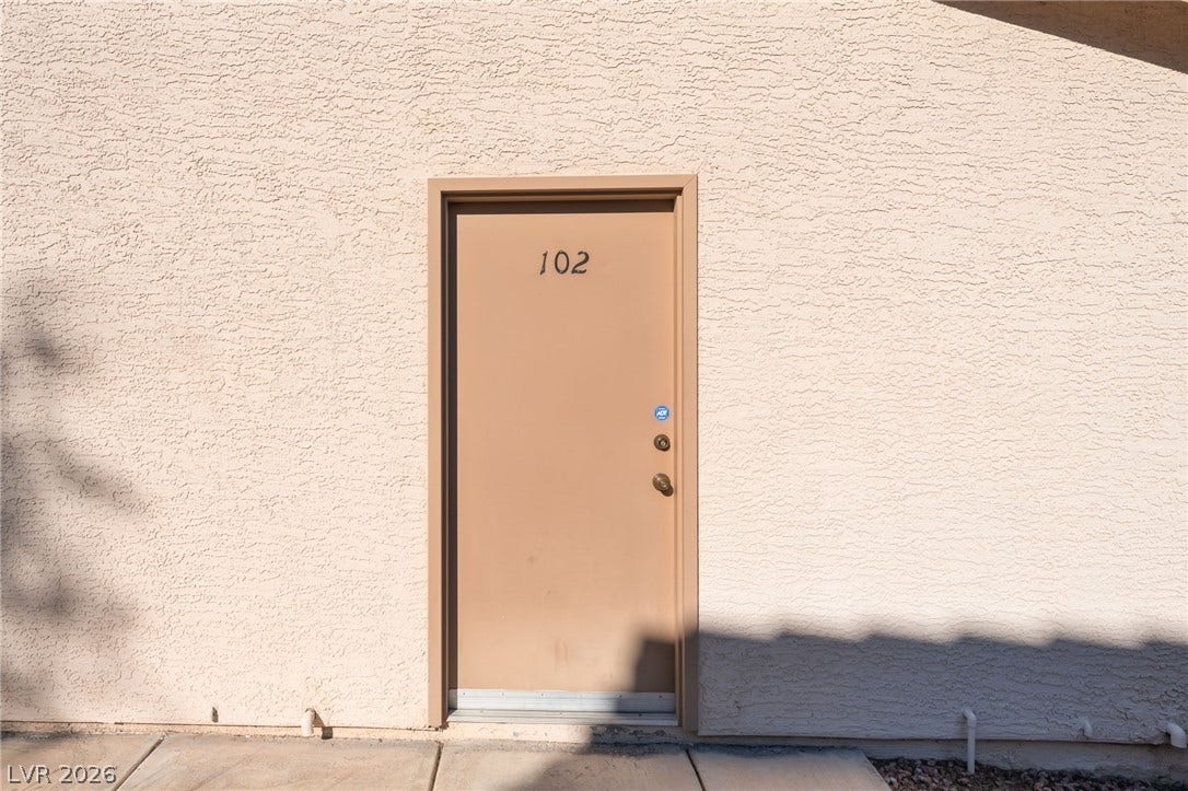 1305 Markwood Circle, #102, Las Vegas, NV 89128 View of exterior entry featuring stucco siding