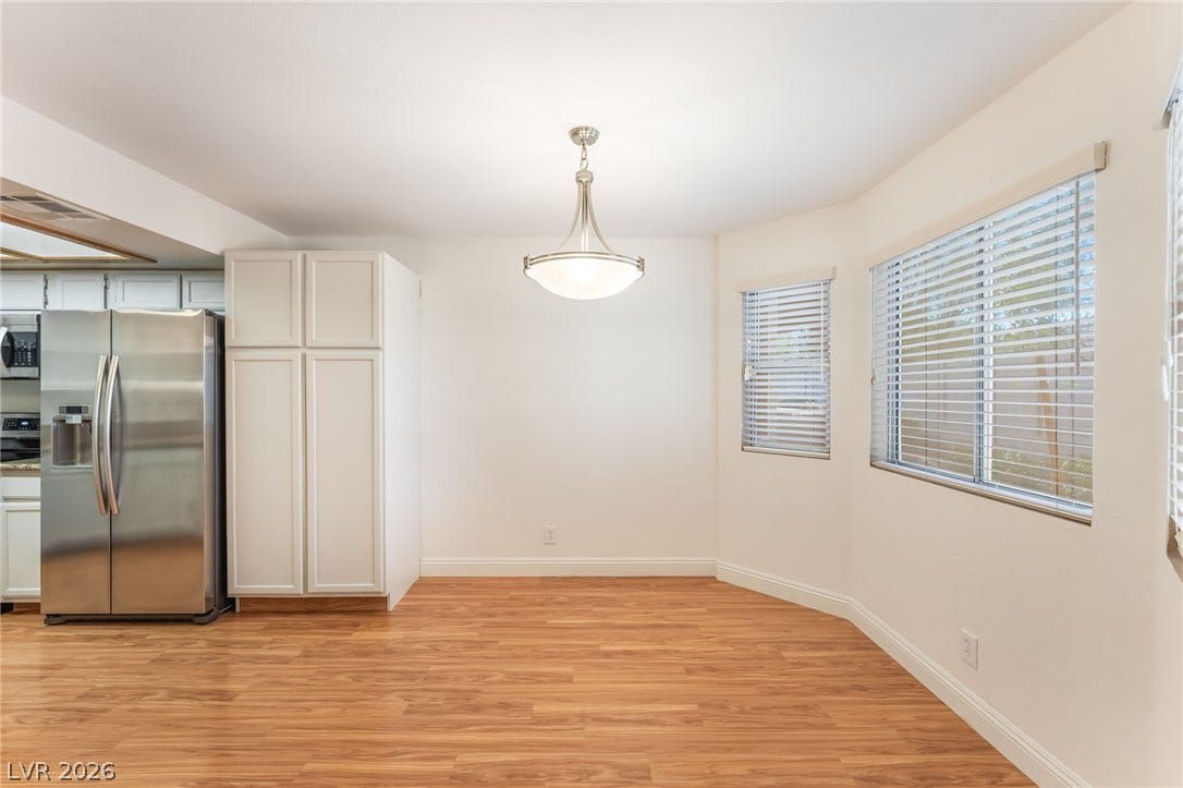 1305 Markwood Circle, #102, Las Vegas, NV 89128 Unfurnished dining area featuring light wood finished floors and baseboards
