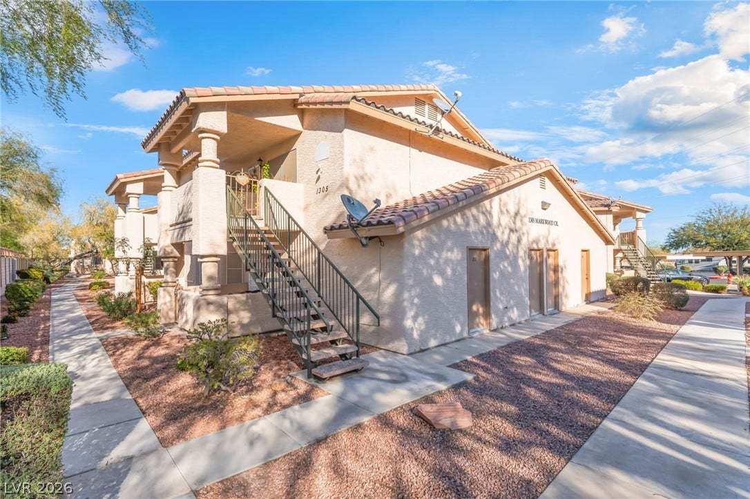 1305 Markwood Circle, #102, Las Vegas, NV 89128 View of home's exterior with a tile roof and stucco siding