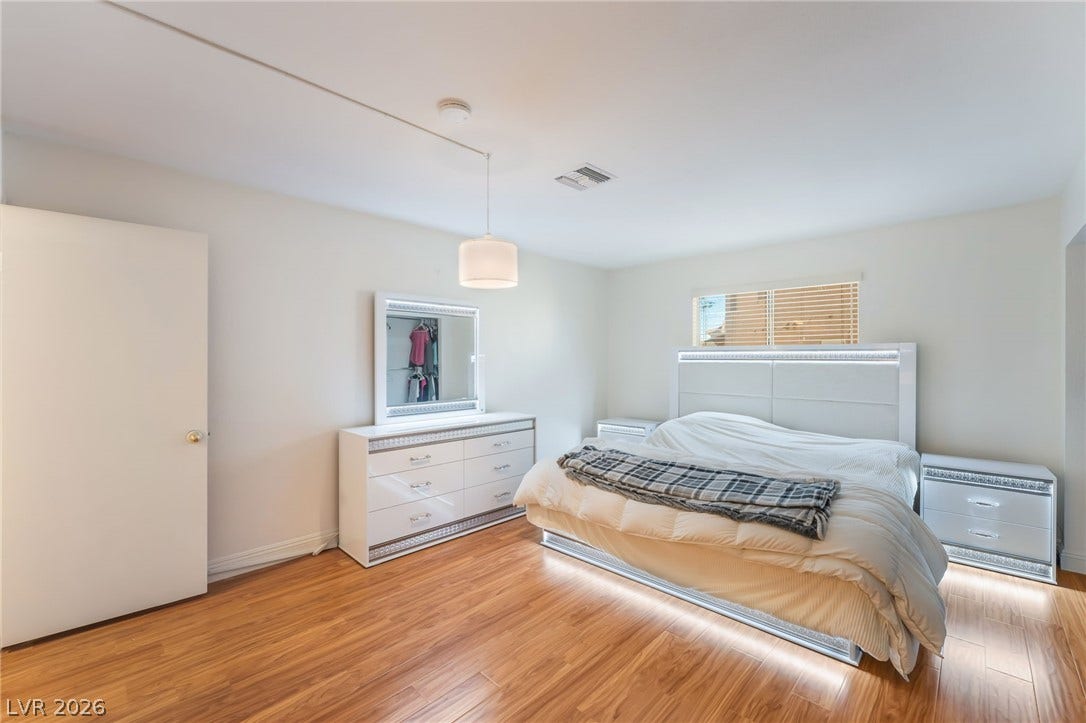1305 Markwood Circle, #102, Las Vegas, NV 89128 Bedroom featuring light wood-type flooring and baseboards