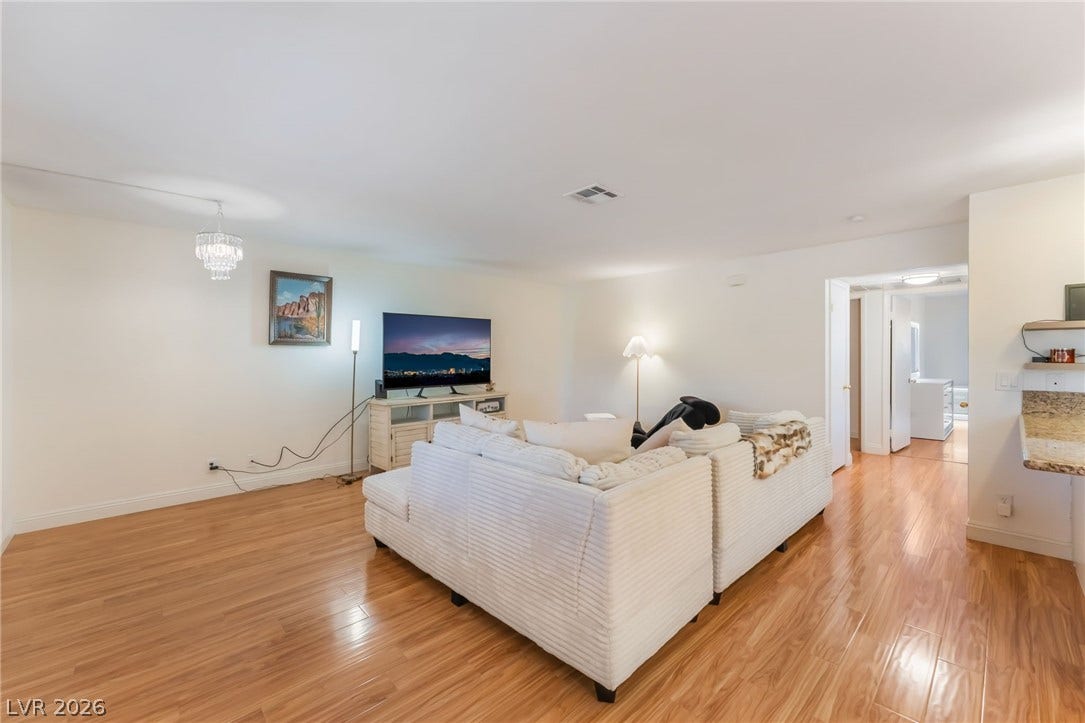 1305 Markwood Circle, #102, Las Vegas, NV 89128 Living room with light wood-style floors and suspended lighting