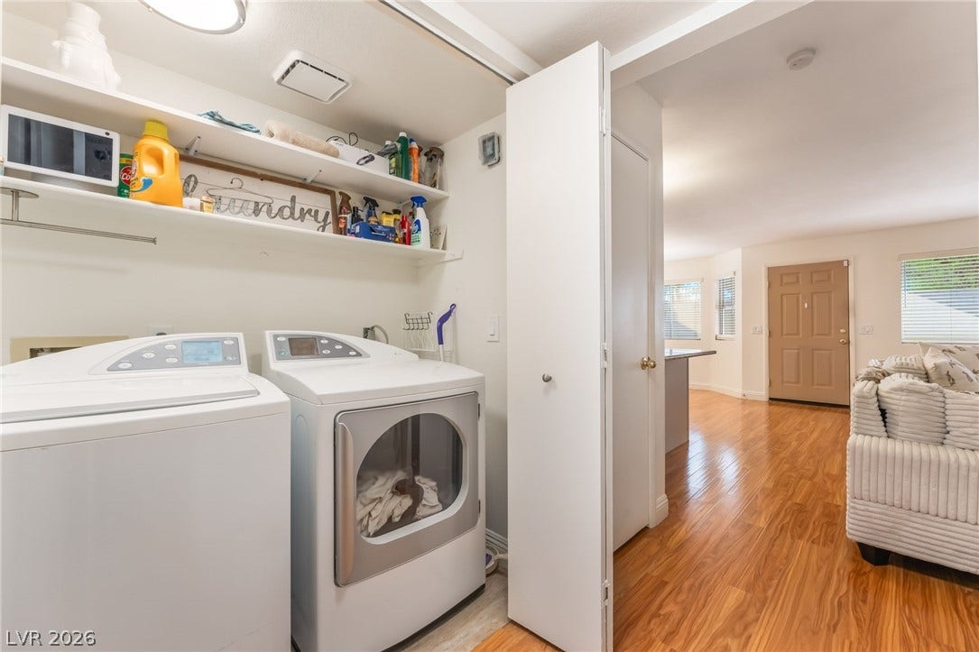 1305 Markwood Circle, #102, Las Vegas, NV 89128 Laundry area with light wood-style flooring and washer and clothes dryer