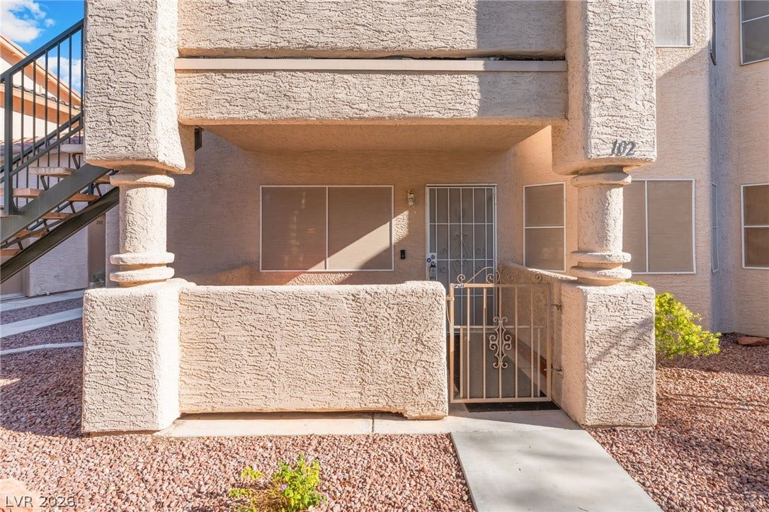 1305 Markwood Circle, #102, Las Vegas, NV 89128 View of exterior entry featuring a gate and stucco siding