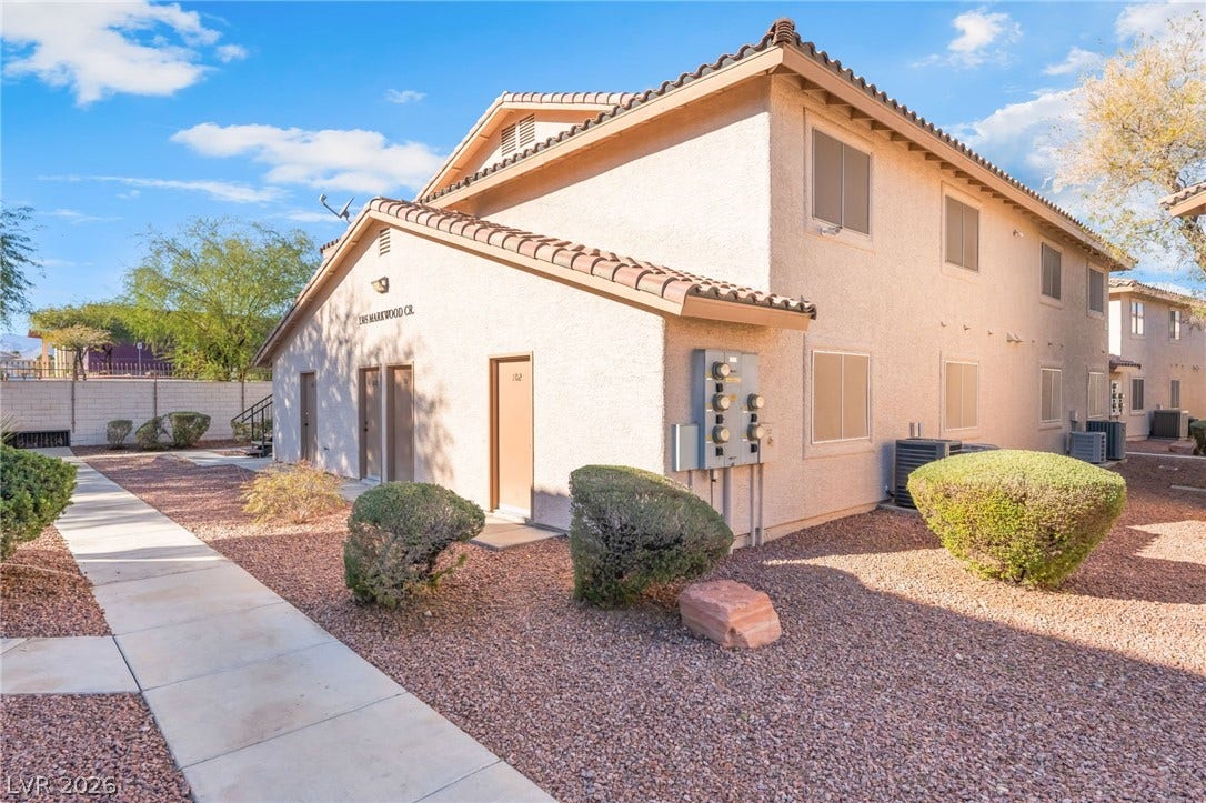 1305 Markwood Circle, #102, Las Vegas, NV 89128 View of side of property with stucco siding and a tiled roof