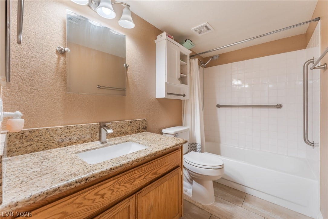 1305 Markwood Circle, #102, Las Vegas, NV 89128 Bathroom featuring a textured wall, vanity, and shower / bath combo