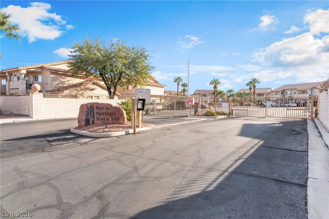 1305 Markwood Circle, #102, Las Vegas, NV 89128 View of asphalt street with a residential view, a gated entry, a gate, and curbs