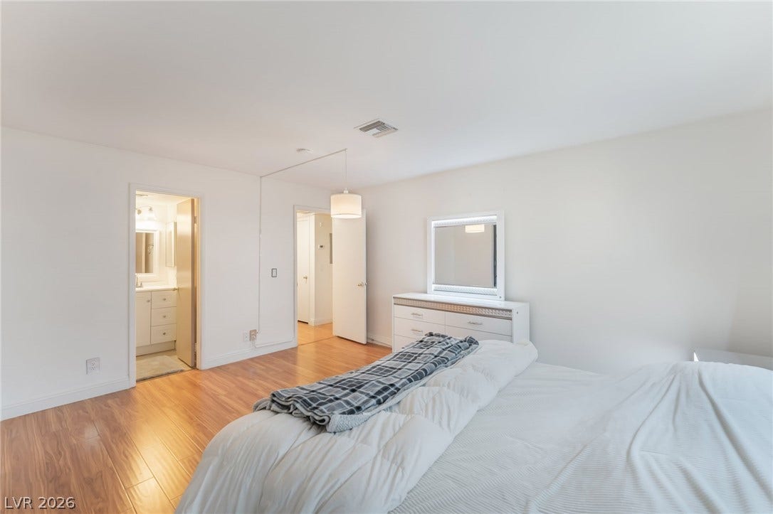 1305 Markwood Circle, #102, Las Vegas, NV 89128 Bedroom with light wood finished floors and connected bathroom