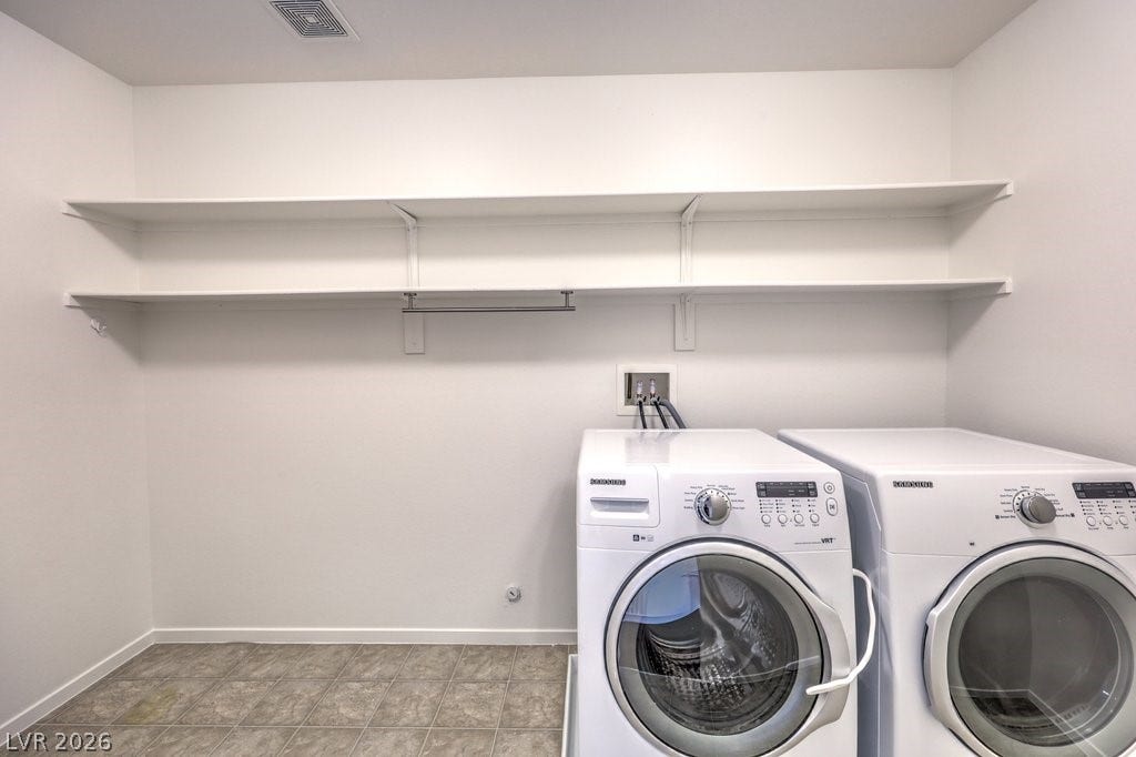8132 Pink Desert Street, North Las Vegas, NV 89085 A dedicated laundry space offering front load modern appliances and open shelving for storage. There is also space for a dog area or an ironing board and hanging rack.