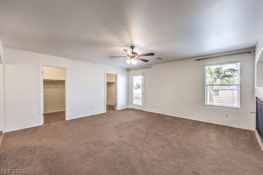 8132 Pink Desert Street, North Las Vegas, NV 89085 This Primary Bedroom is AMAZING! There is a 3-way fireplace, 2 spacious walk-in closets. A Balcony overlooking the pool.