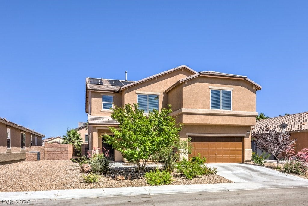 8132 Pink Desert Street, North Las Vegas, NV 89085 A well-maintained facade features a solar heating system for the swimming pool and a welcoming xeriscaped front yard. Potential RV parking could be added on the left side.