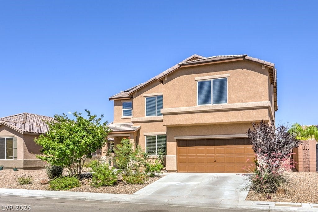 8132 Pink Desert Street, North Las Vegas, NV 89085 A terracotta-hue facade was just painted. Presenting a welcoming two-story residence with a neatly manicured desert-style landscape.