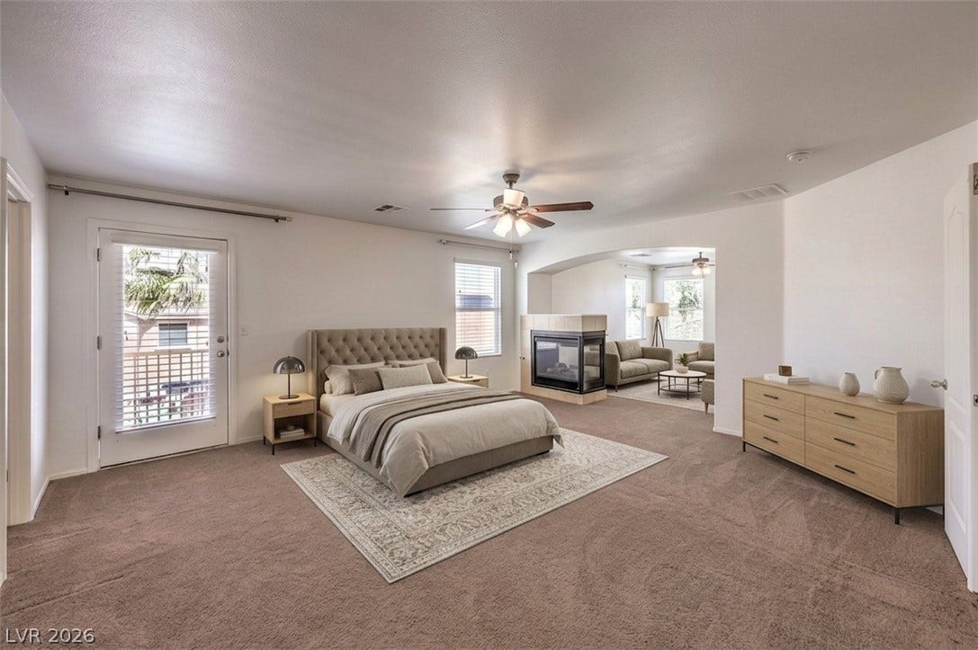 8132 Pink Desert Street, North Las Vegas, NV 89085 A spacious bedroom suite connects seamlessly to a cozy sitting area with a fireplace.