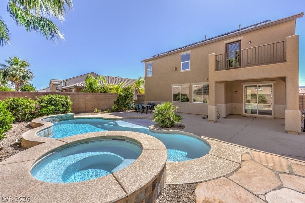8132 Pink Desert Street, North Las Vegas, NV 89085 This amazing backyard features a pool, spa, covered patio and balcony for the primary bedroom. There is plenty of open space for guests, or a quiet retreat.