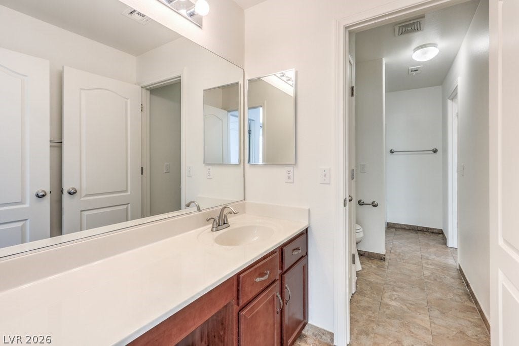 8132 Pink Desert Street, North Las Vegas, NV 89085 A pristine vanity offers generous counter space in this well-appointed bathroom. This is the shared Jack & Jill bathroom offering private sinks and a shared tub and toilet.