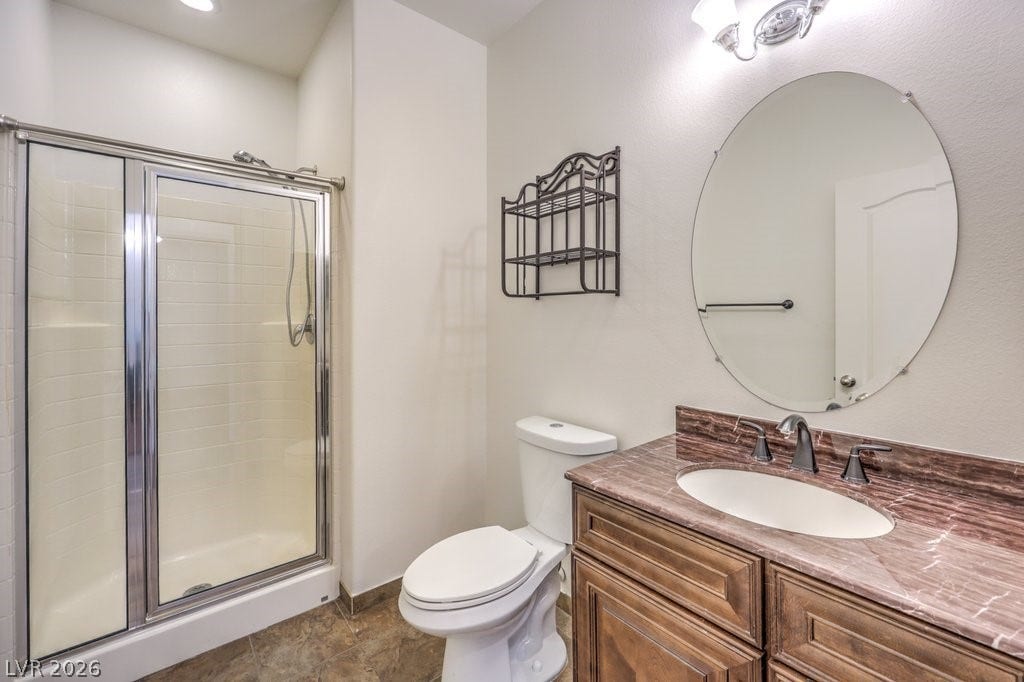 8132 Pink Desert Street, North Las Vegas, NV 89085 Functional 3/4 bathroom with shower and a vanity featuring a single sink and marble countertop.