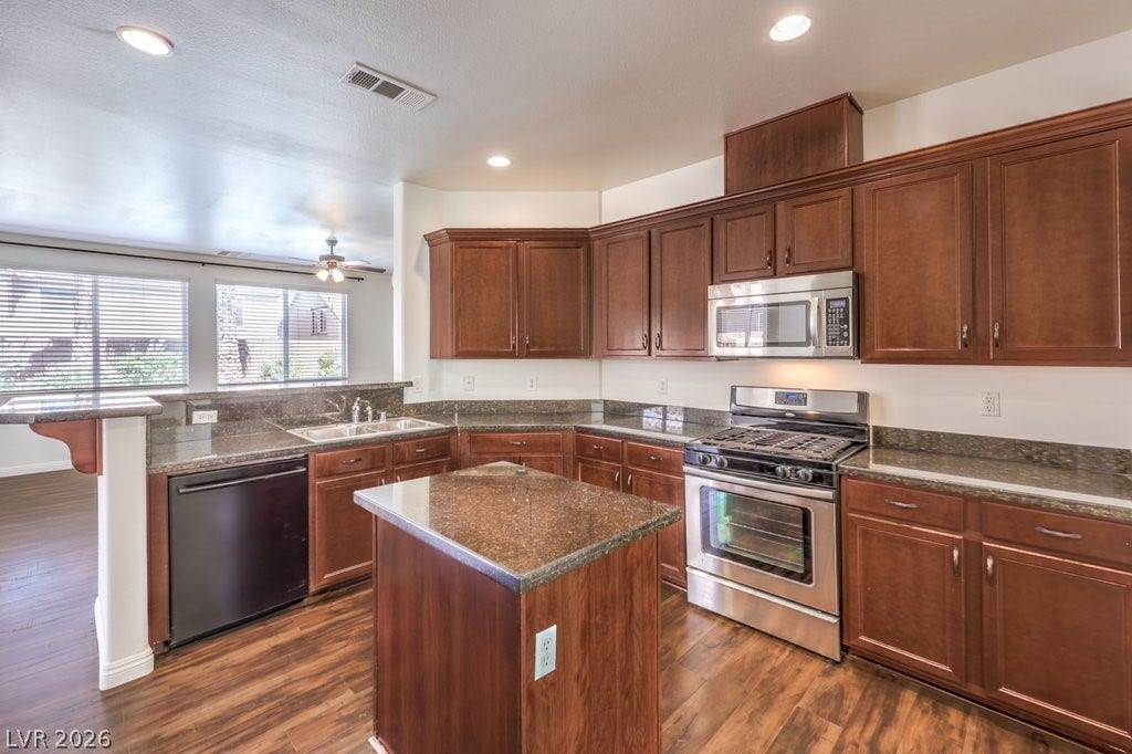 8132 Pink Desert Street, North Las Vegas, NV 89085 A well-appointed kitchen showcasing rich cabinetry and contemporary stainless appliances, perfect for culinary adventures.