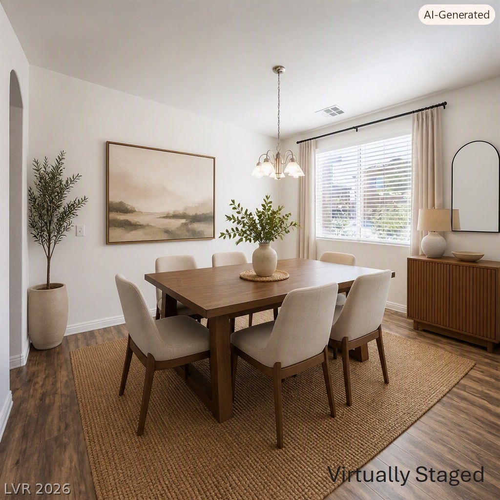 8132 Pink Desert Street, North Las Vegas, NV 89085 Warm wood flooring extends throughout this well-lit dining area, featuring a modern chandelier and ample space for gatherings. This area has been Virtually Staged using AI and is for inspiration only.
