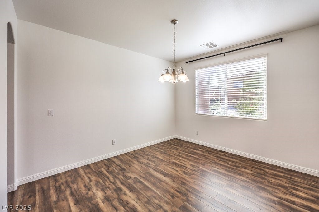 8132 Pink Desert Street, North Las Vegas, NV 89085 A refined dining room offering rich wood flooring and natural light through a generous window.