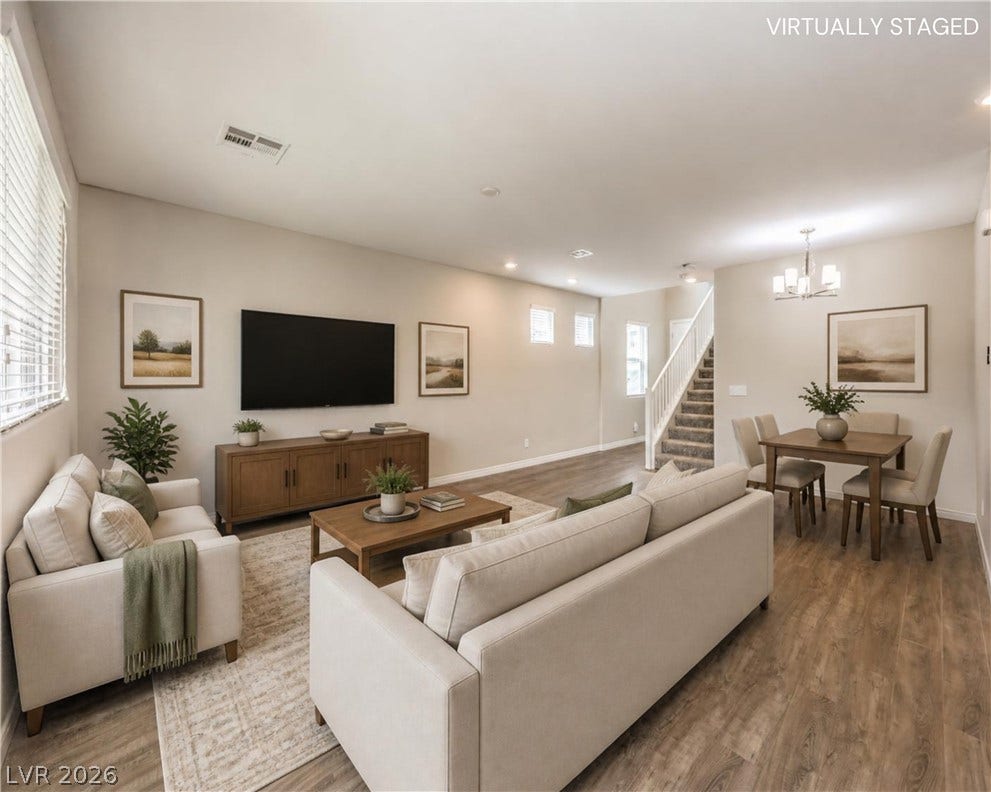 6934 Denio Island Street, North Las Vegas, NV 89084 An open floorplan seamlessly connects the comfortable living area with the adjacent dining space.