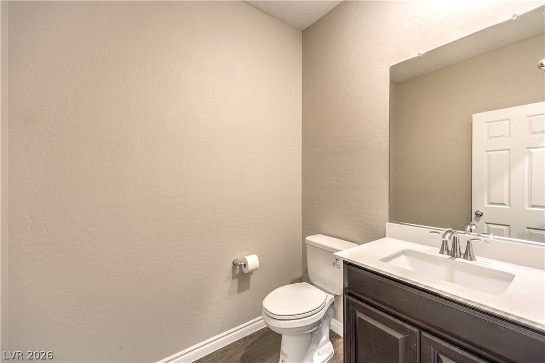 6934 Denio Island Street, North Las Vegas, NV 89084 Smooth walls and a modern vanity define this clean powder room.