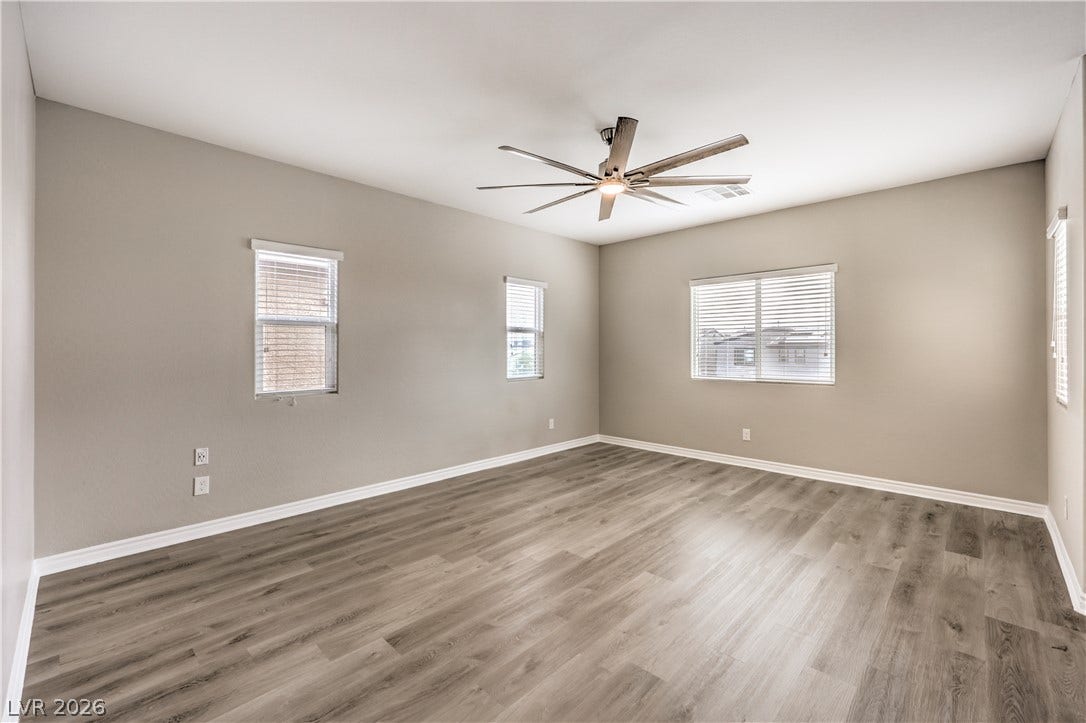 6934 Denio Island Street, North Las Vegas, NV 89084 Generous windows fill this versatile space with natural light over durable wood-look flooring.